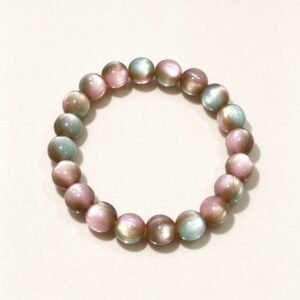 Multicolor cat's eye feng shui bracelet with rainbow crystal beads on cream white background